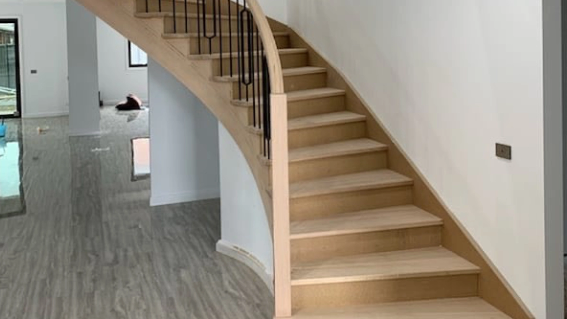 Banner slider showing curved geometric timber staircase