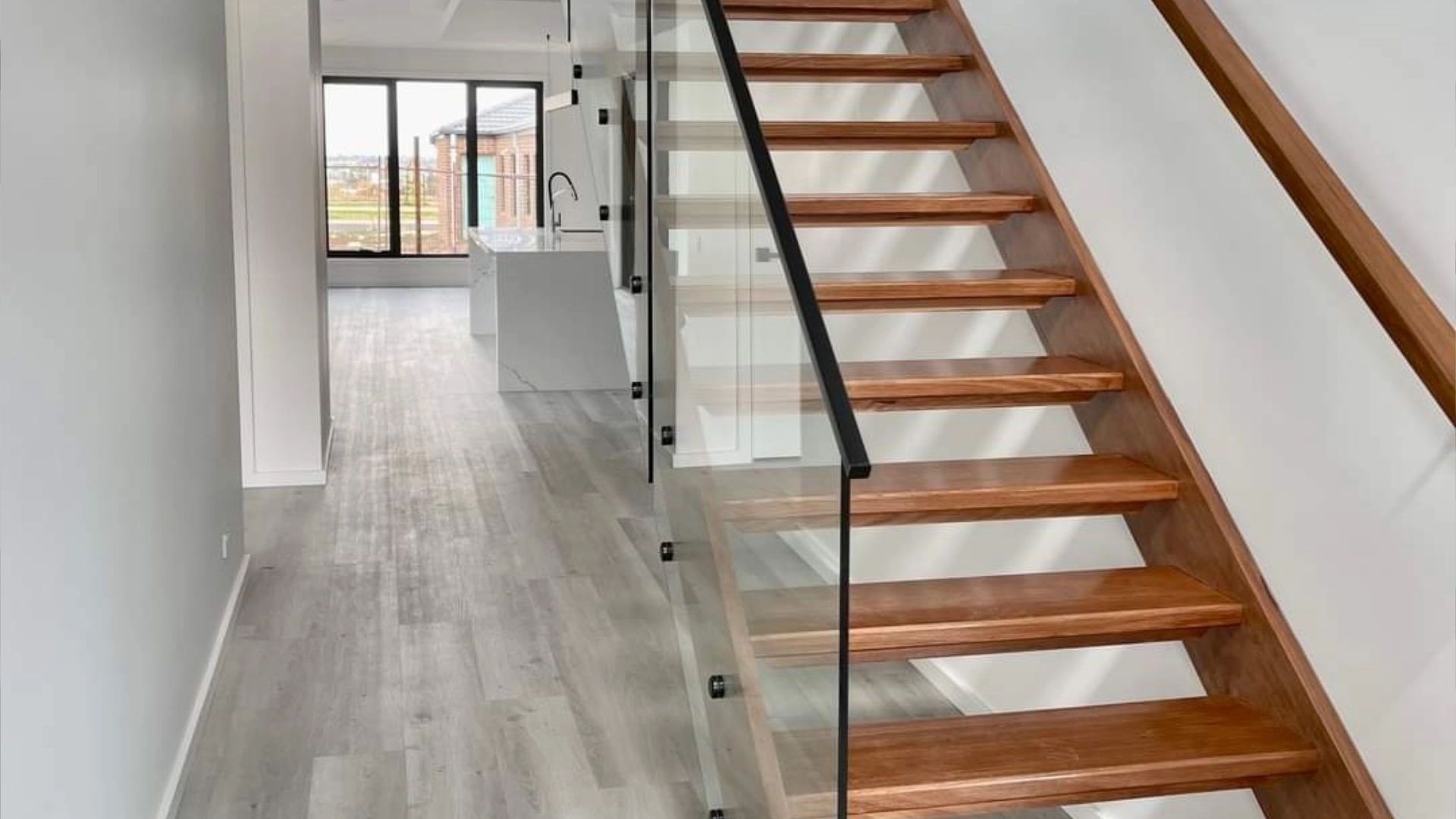 Banner slider showing open timber staircase in a modern interior