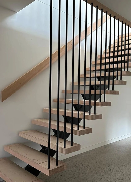 Timber staircase with black vertical bar balustrade