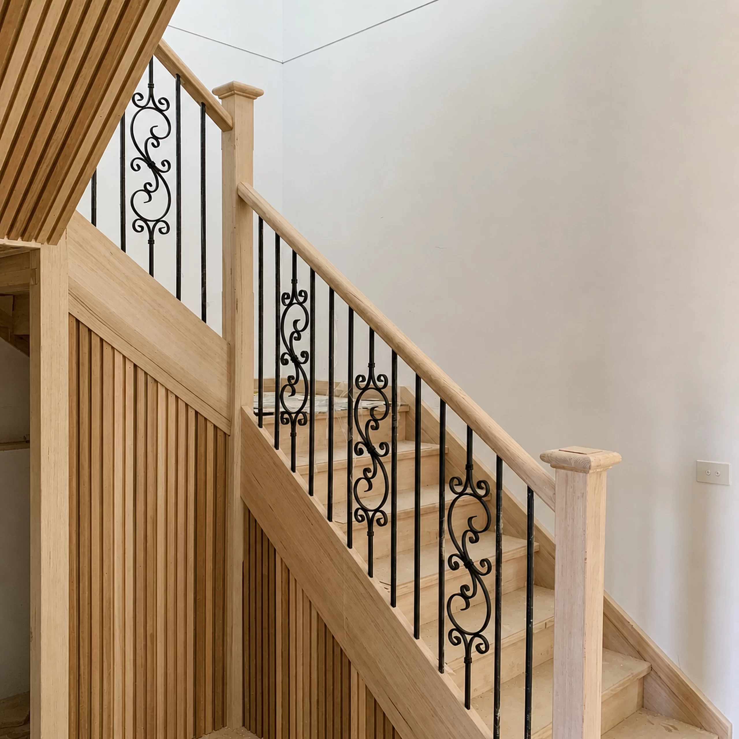 Timber staircase with decorative lacework balustrade by Planet Stairs