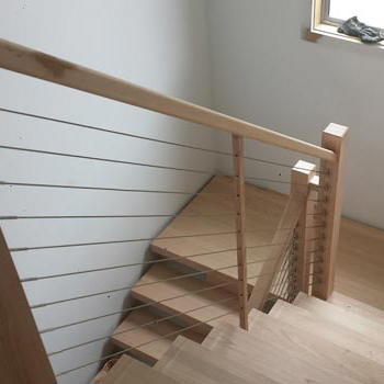 Timber staircase with horizontal balustrade rails in a home interior
