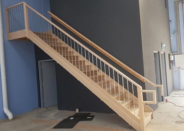 Commercial timber staircase with balustrade in a tall interior space